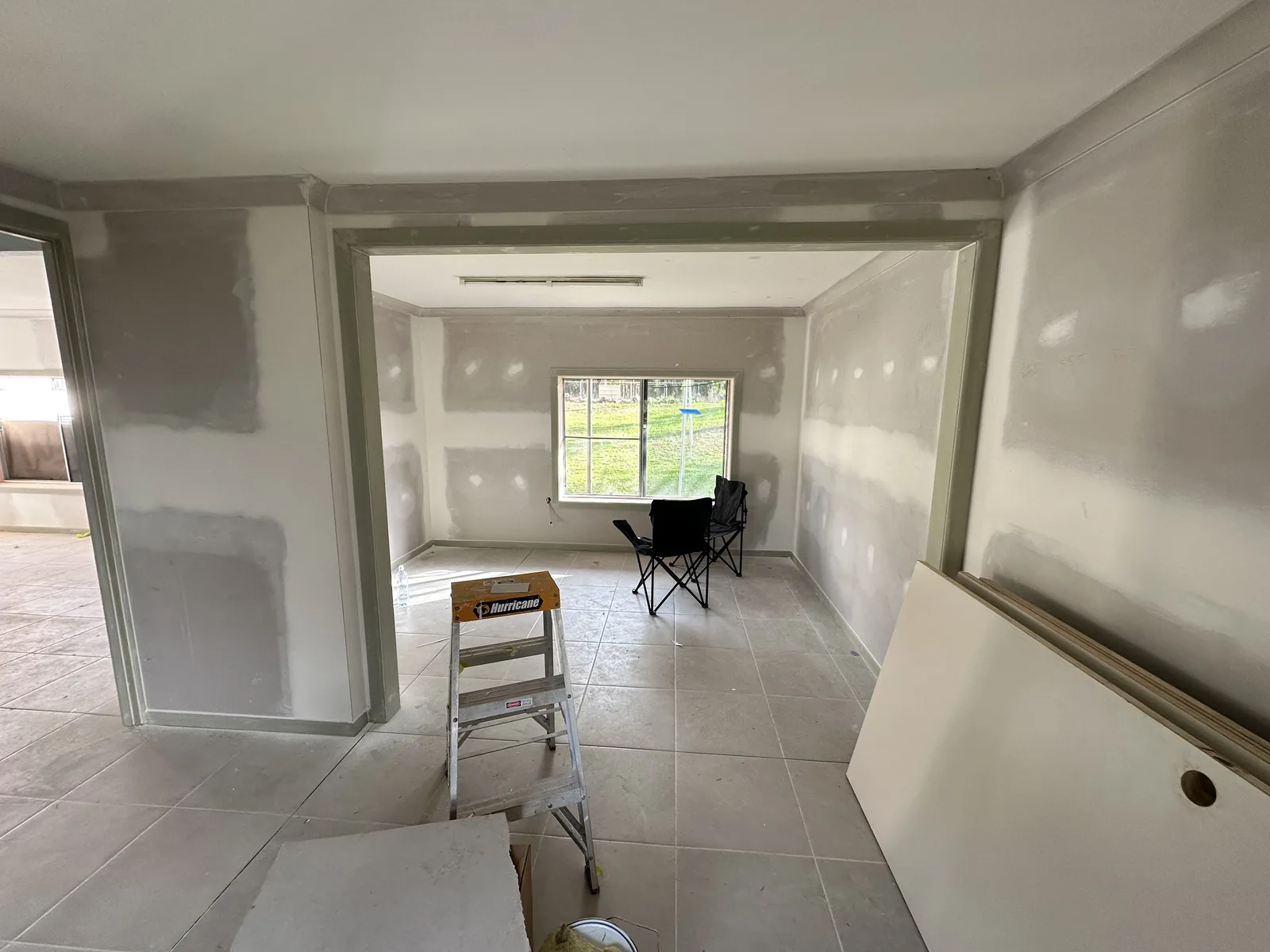 Room interior with bare plaster walls before painting